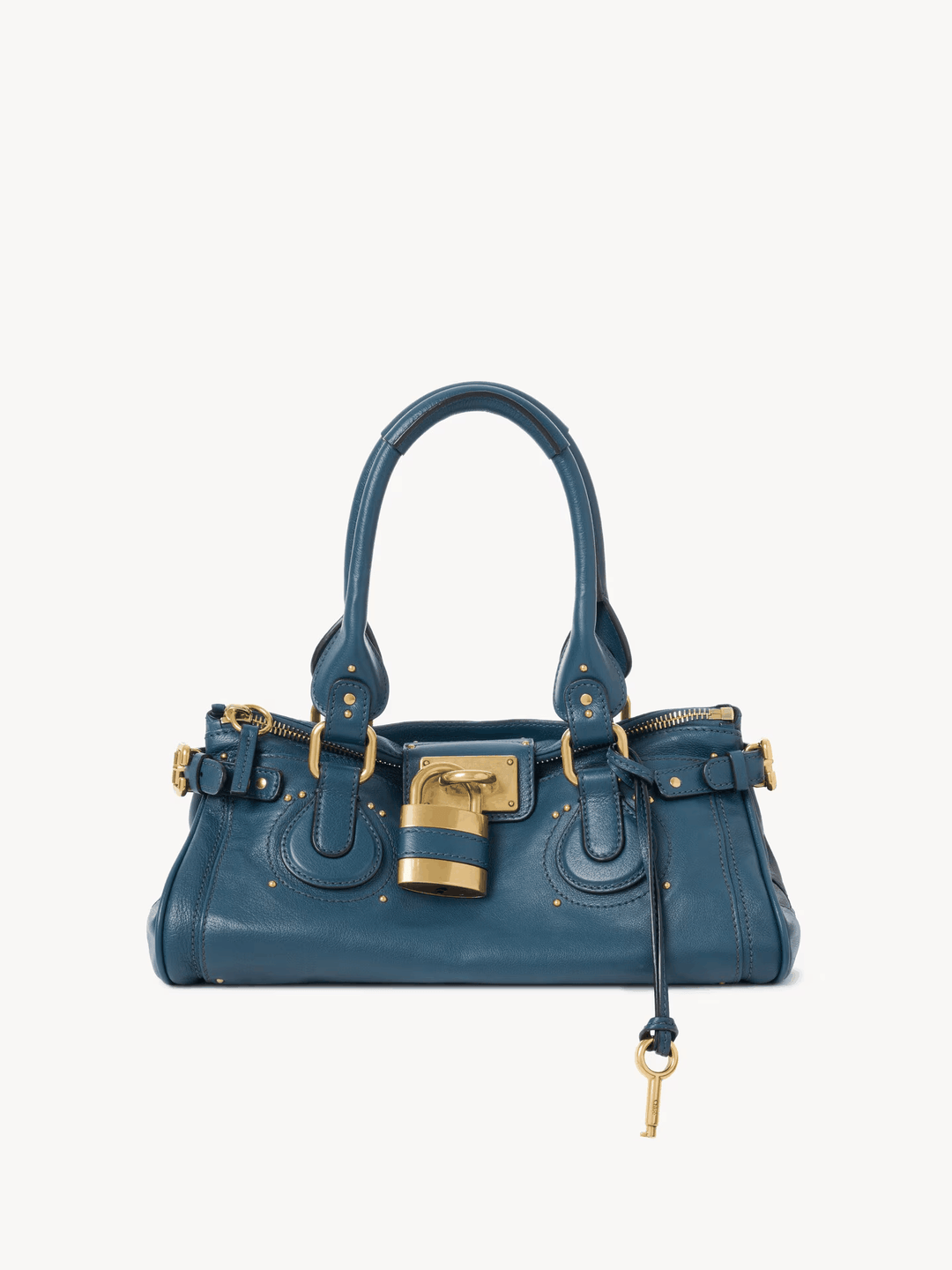 Blue Marcelle Lock Handbag with oversized gold lock, double handles, and smooth vegan leather