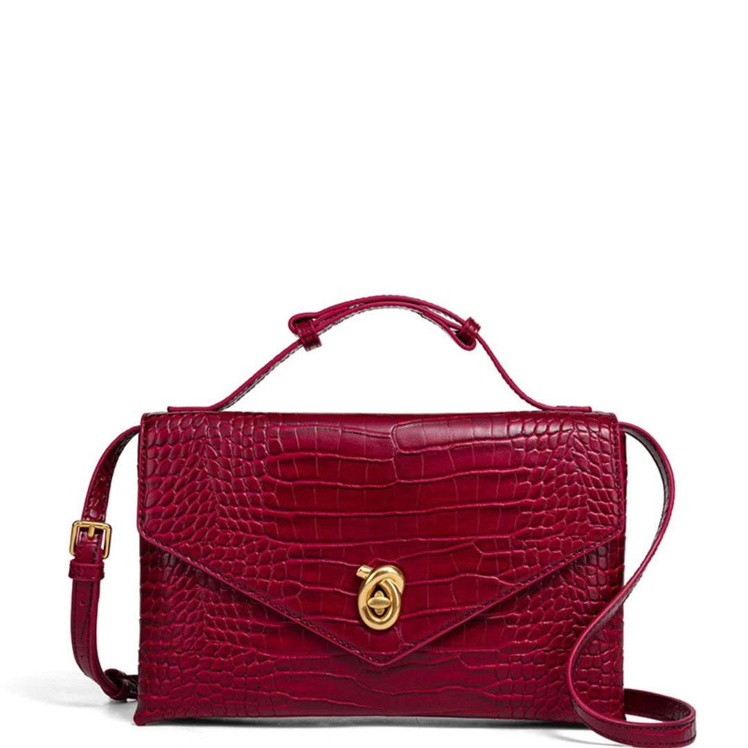 Celeste Envelope Bag in black vegan leather with gold clasp and detachable strap