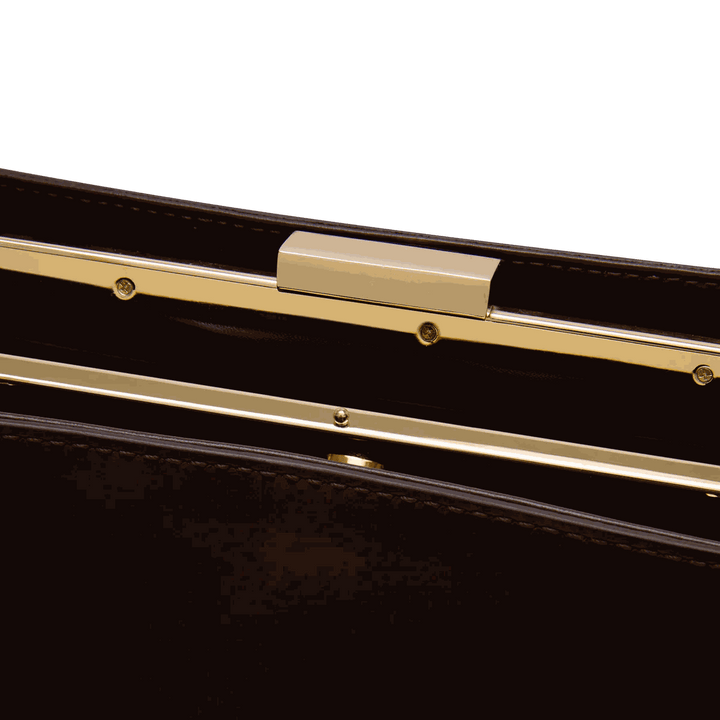 Close-up of Leclair Handbag's sleek, structured frame closure with gold-tone detailing, showcasing its minimalist and sophisticated design.