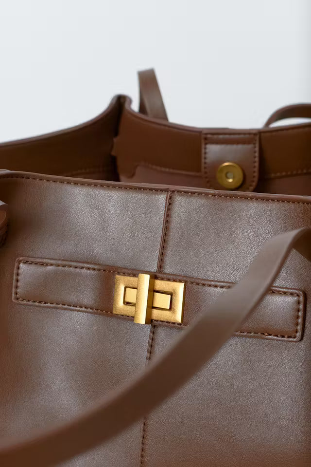 Brown vegan leather tote bag with gold clasp and minimalist design