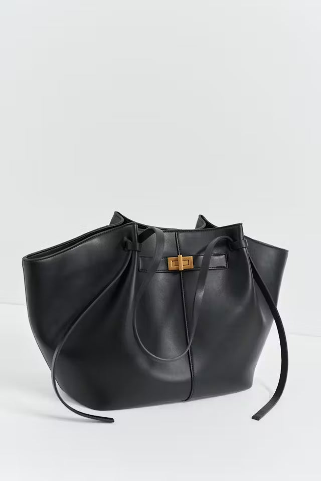 Black Delair Tote Bag made from soft vegan leather with relaxed silhouette and gold clasp detail