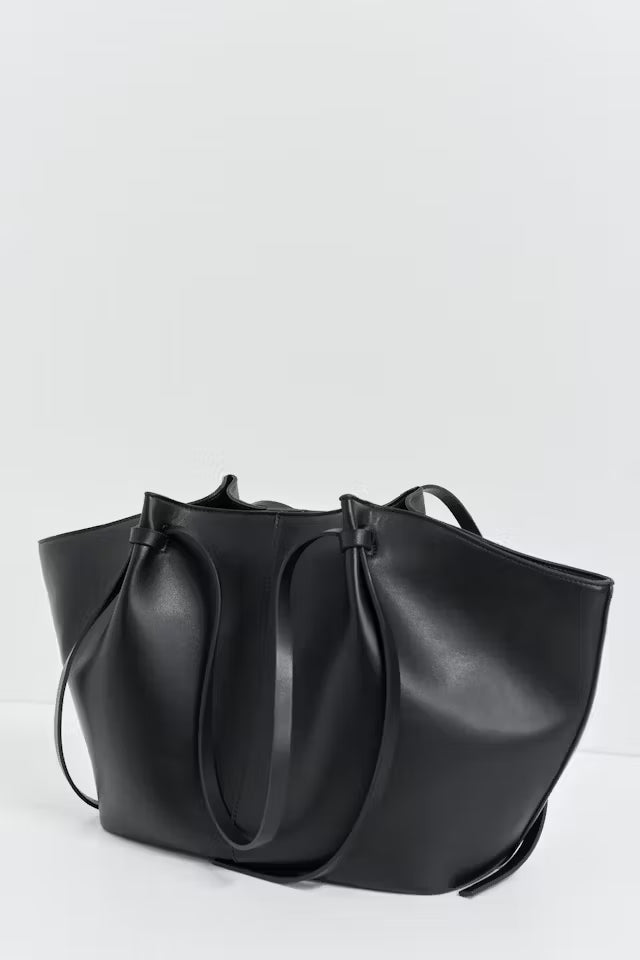 Black vegan leather Delair tote bag with soft, spacious design and minimalist style