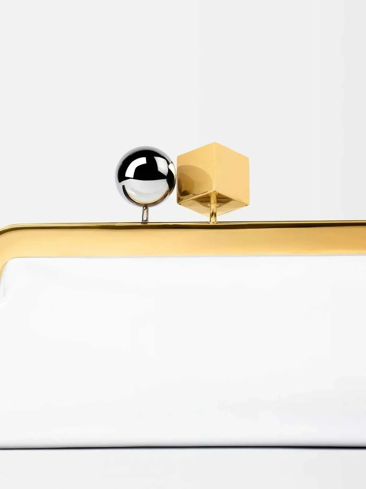 Close-up of dual-metal clasp on Venti Clutch Bag with smooth vegan leather and bold gold frame