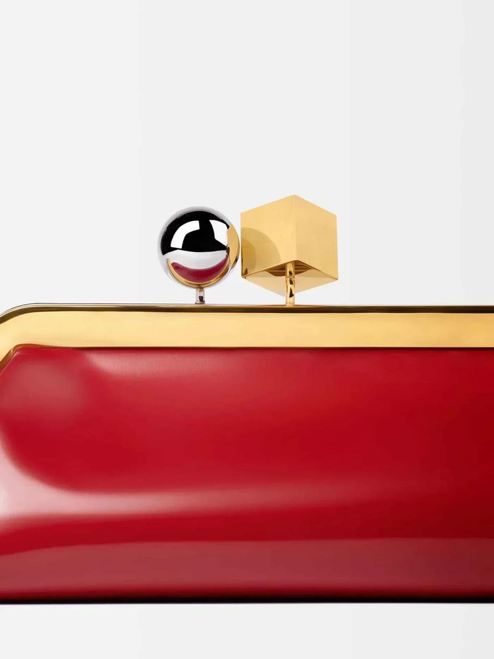 Red Venti clutch bag in smooth vegan leather with bold gold frame and dual-metal clasp detail