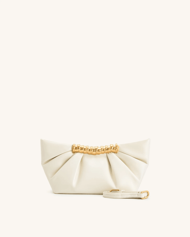 Modern Lia clutch bag in smooth vegan leather with sculptural gold bar and detachable strap