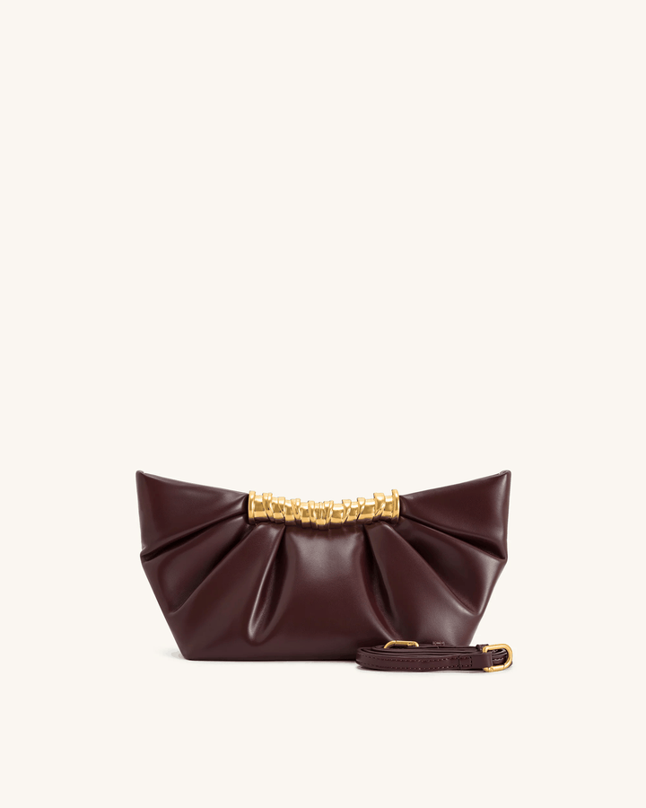 Lia Clutch bag in smooth vegan leather with sculptural gold bar and detachable strap