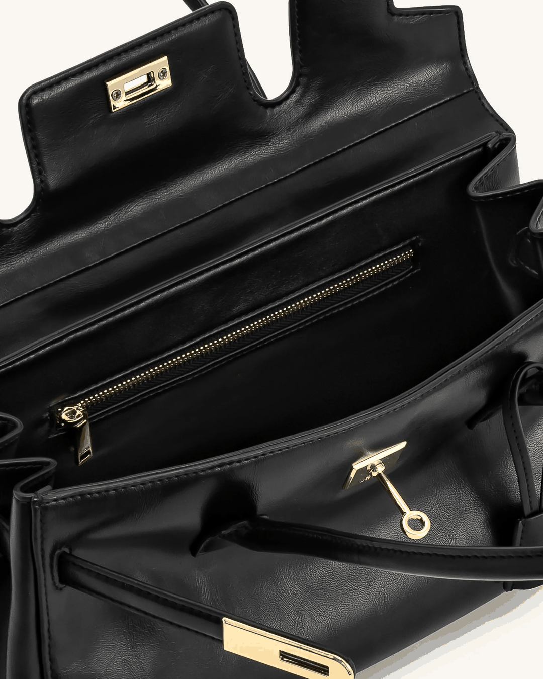 Black Marisse shoulder bag with smooth finish, gold hardware, zipper pocket, and long handles for easy carrying.