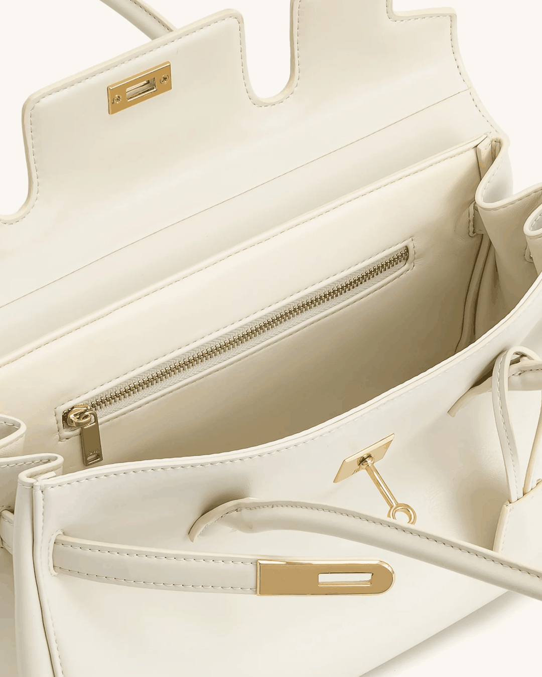 Cream structured shoulder bag with gold details and zippered interior pocket