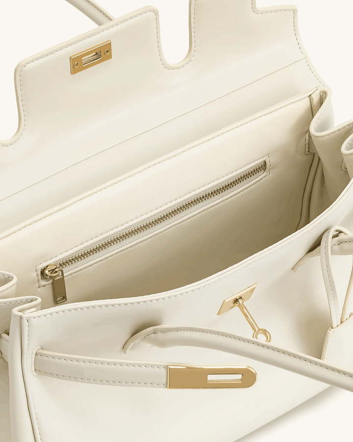 Cream structured shoulder bag with gold details and zippered interior pocket