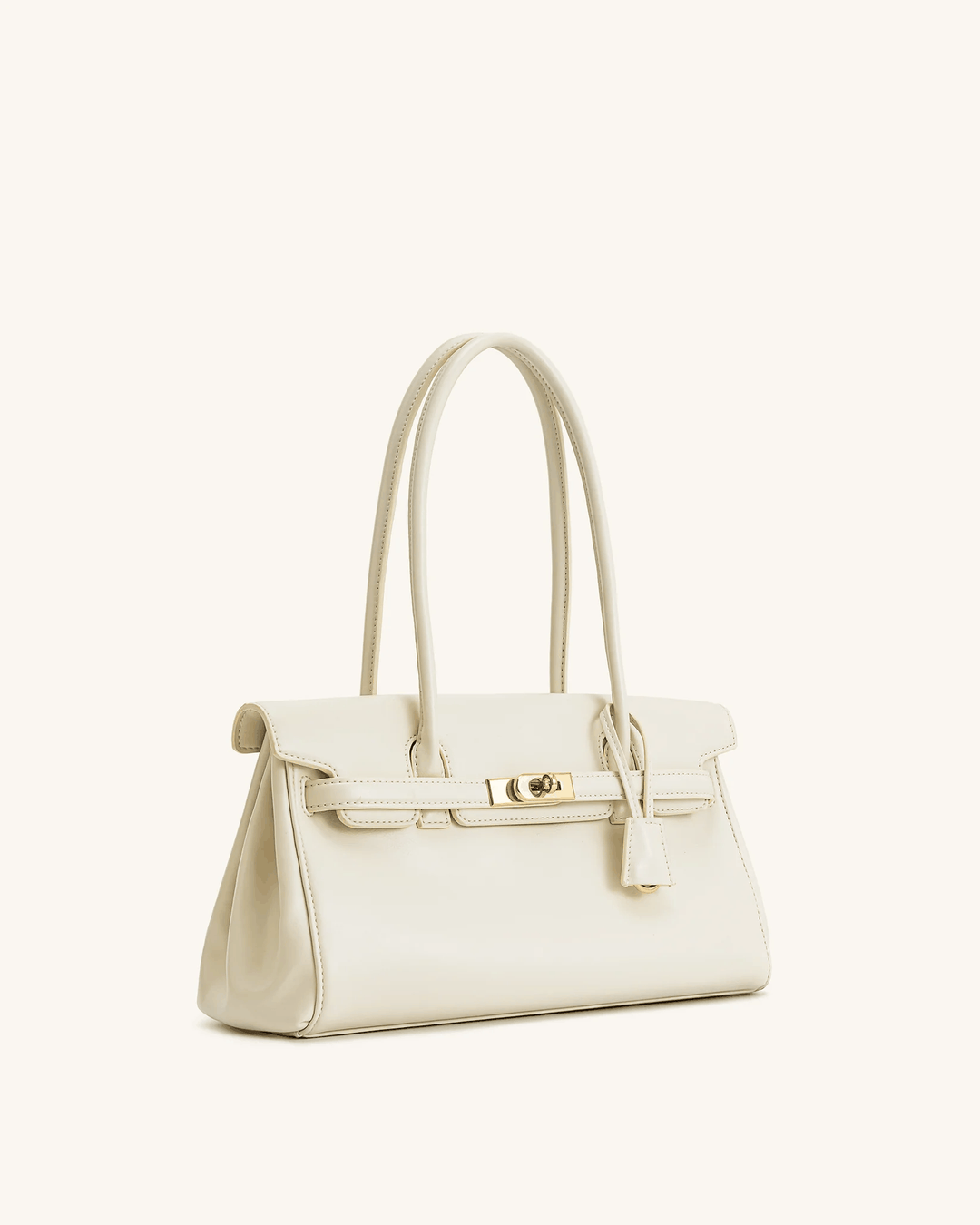 Cream structured shoulder bag with gold hardware and long handles for versatile carrying
