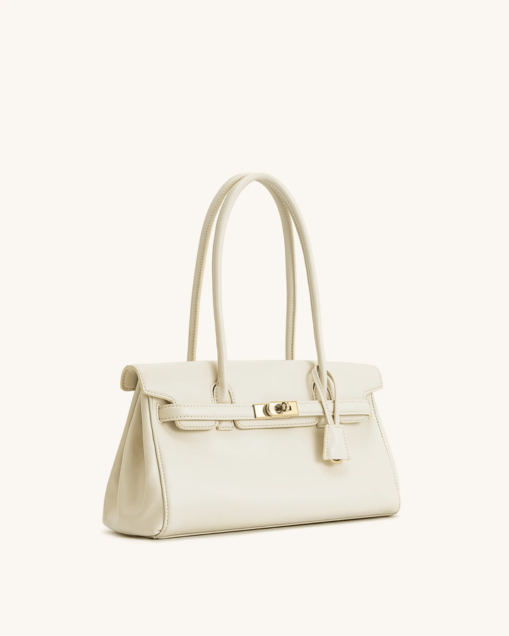 Cream structured shoulder bag with gold hardware and long handles for versatile carrying