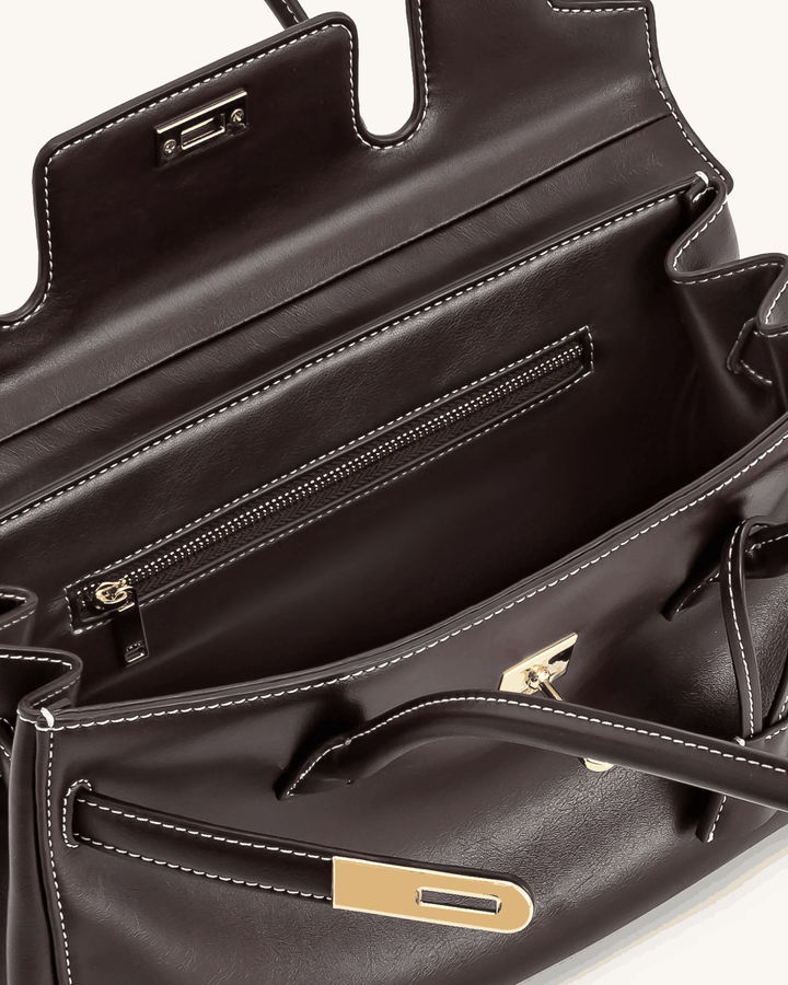 Interior view of Marisse shoulder bag with smooth black finish and gold zipper details