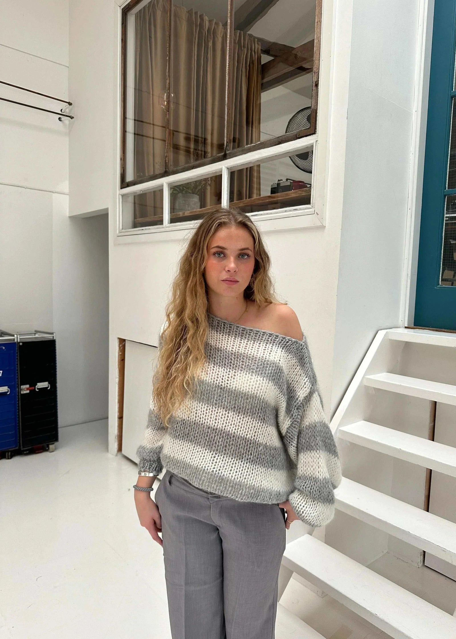 Woman wearing oversized grey Anna knit sweater with drop shoulders and ribbed knit pattern