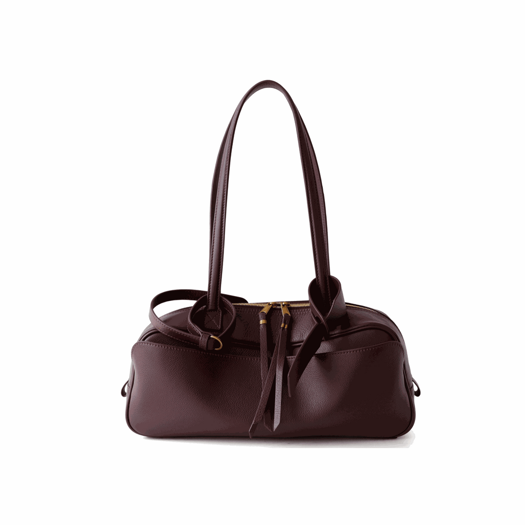 Adrienne Bowling Bag in premium pebbled vegan leather with dual handles and adjustable crossbody strap