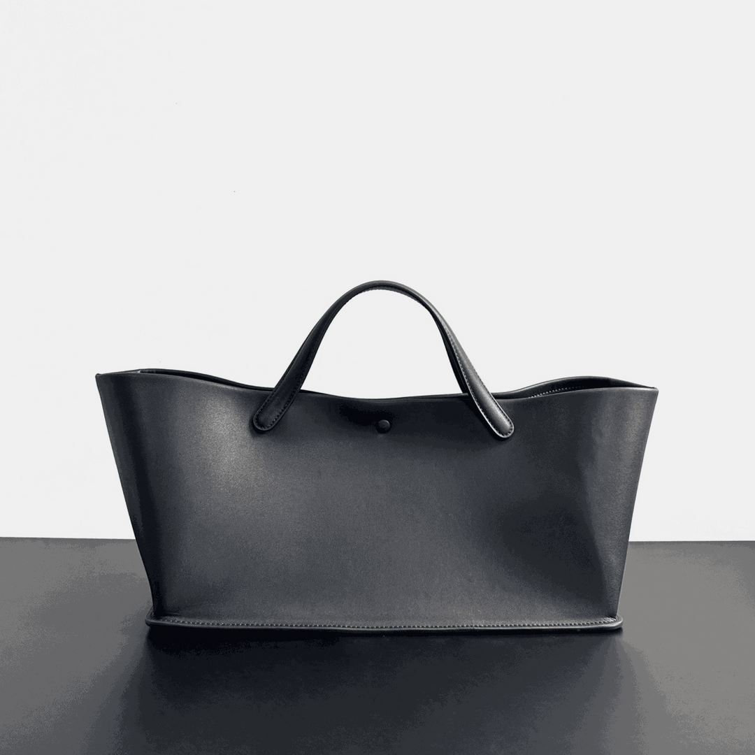 Cassandra Dome Handbag in premium top-grain leather with dome silhouette and strapless design