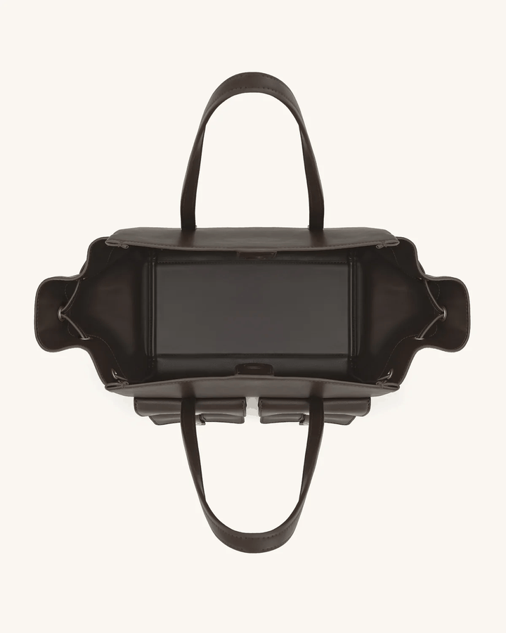 Black Tilda tote bag with dual front pockets, extended sides, and metallic accents, shown open from above