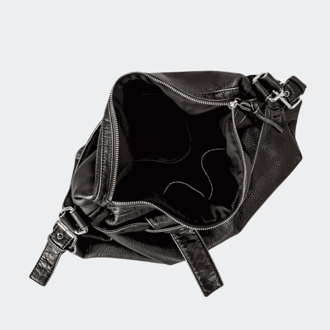 Black retro leather bag on a light beige background