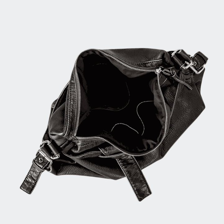 Black retro leather bag on a light beige background