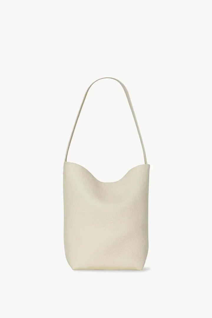 Minimalist beige vegan leather hobo shoulder bag with curved top and single strap