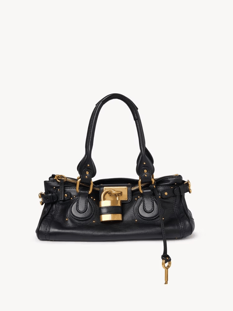 Black Marcelle Lock Handbag with oversized gold lock and double handles in vegan leather
