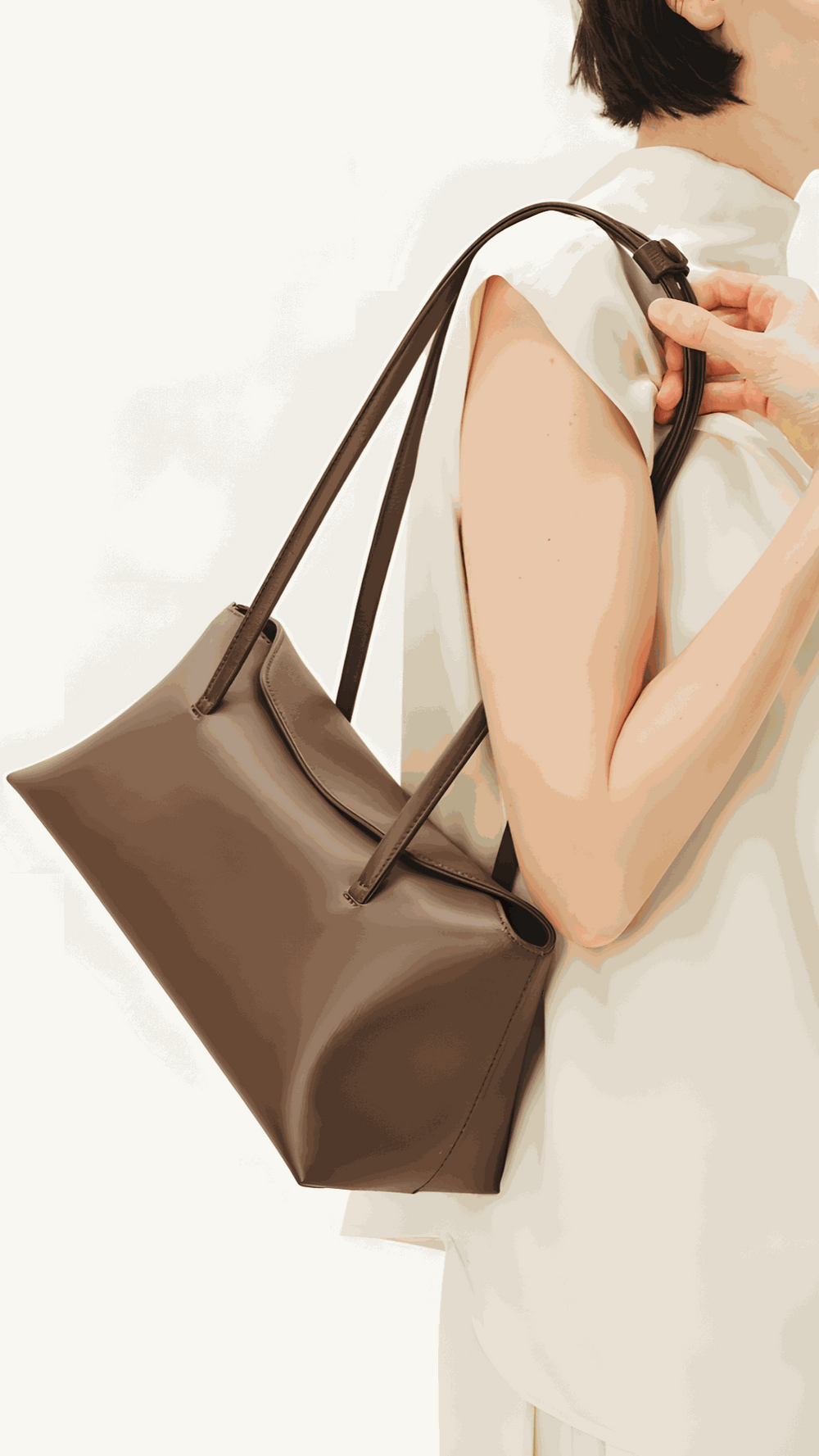 Christelle leather shoulder bag in brown vegan leather with dual straps and magnetic closure worn on shoulder