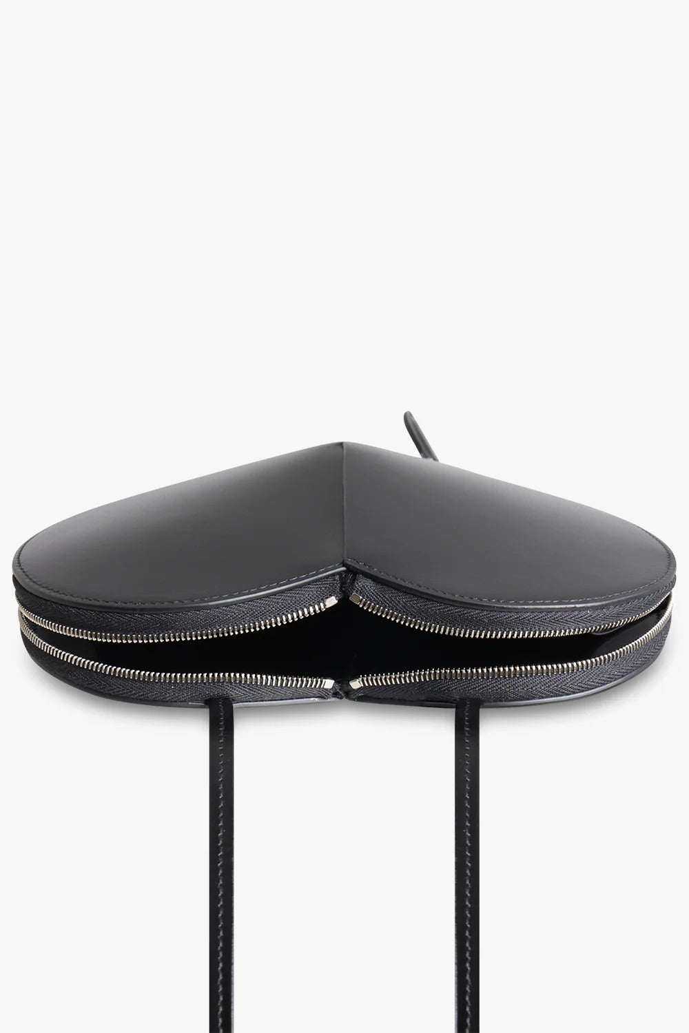 Black heart-shaped 3D vegan leather crossbody bag with dual zip closure and adjustable strap