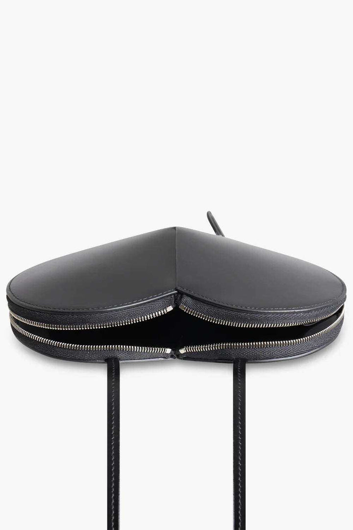 Black heart-shaped 3D vegan leather crossbody bag with dual zip closure and adjustable strap