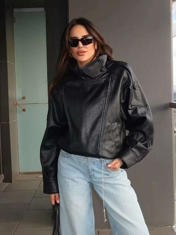 Oversized faux leather jacket with high funnel neck and asymmetrical front panel in black