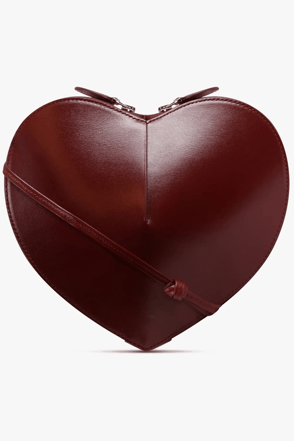 Heart-shaped sculptural vegan leather crossbody bag with dual zip closure and adjustable strap