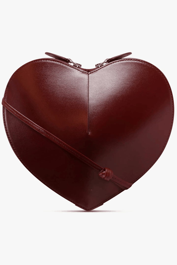 Heart-shaped sculptural vegan leather crossbody bag with dual zip closure and adjustable strap