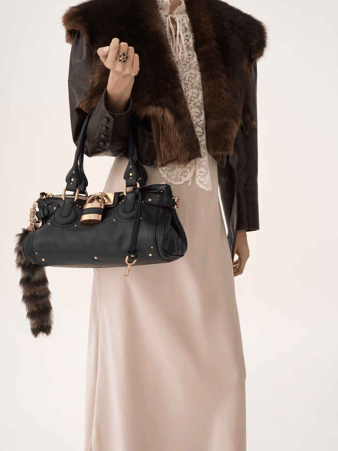 Black Marcelle Lock Handbag with oversized gold lock and double handles in vegan leather