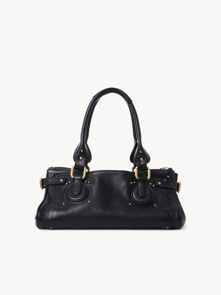 Black Marcelle Lock handbag with oversized gold lock and double handles made of smooth vegan leather.